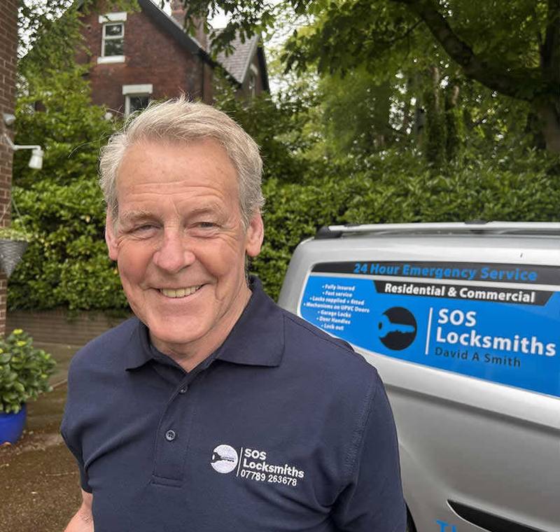 David A Smith, owner of SOS Locksmiths, smiling outside a customer’s home